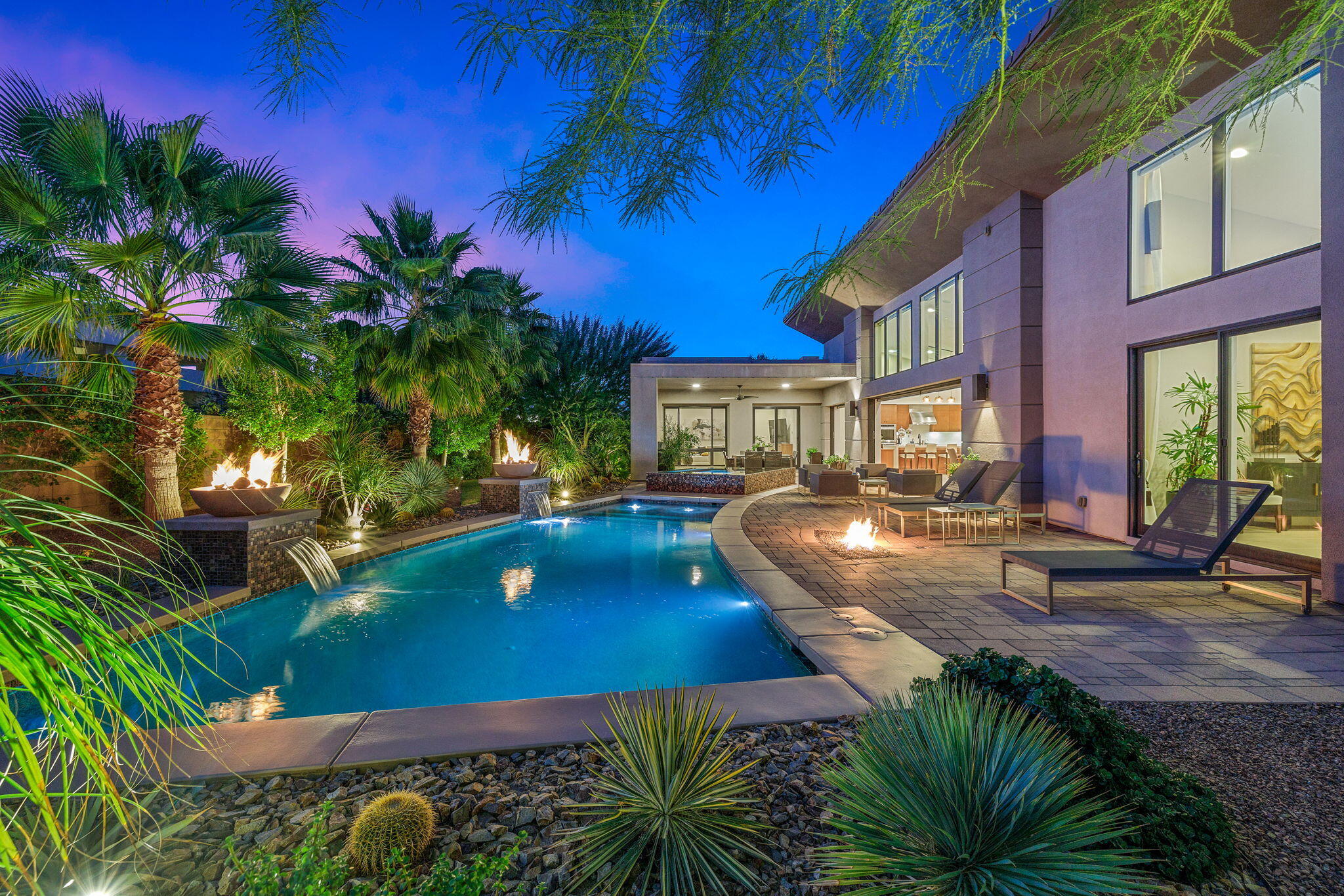 5 Via Merenda Rancho Mirage, CA 92270 - Photo 5 of 84 a view of a swimming pool with lawn chairs under an umbrella