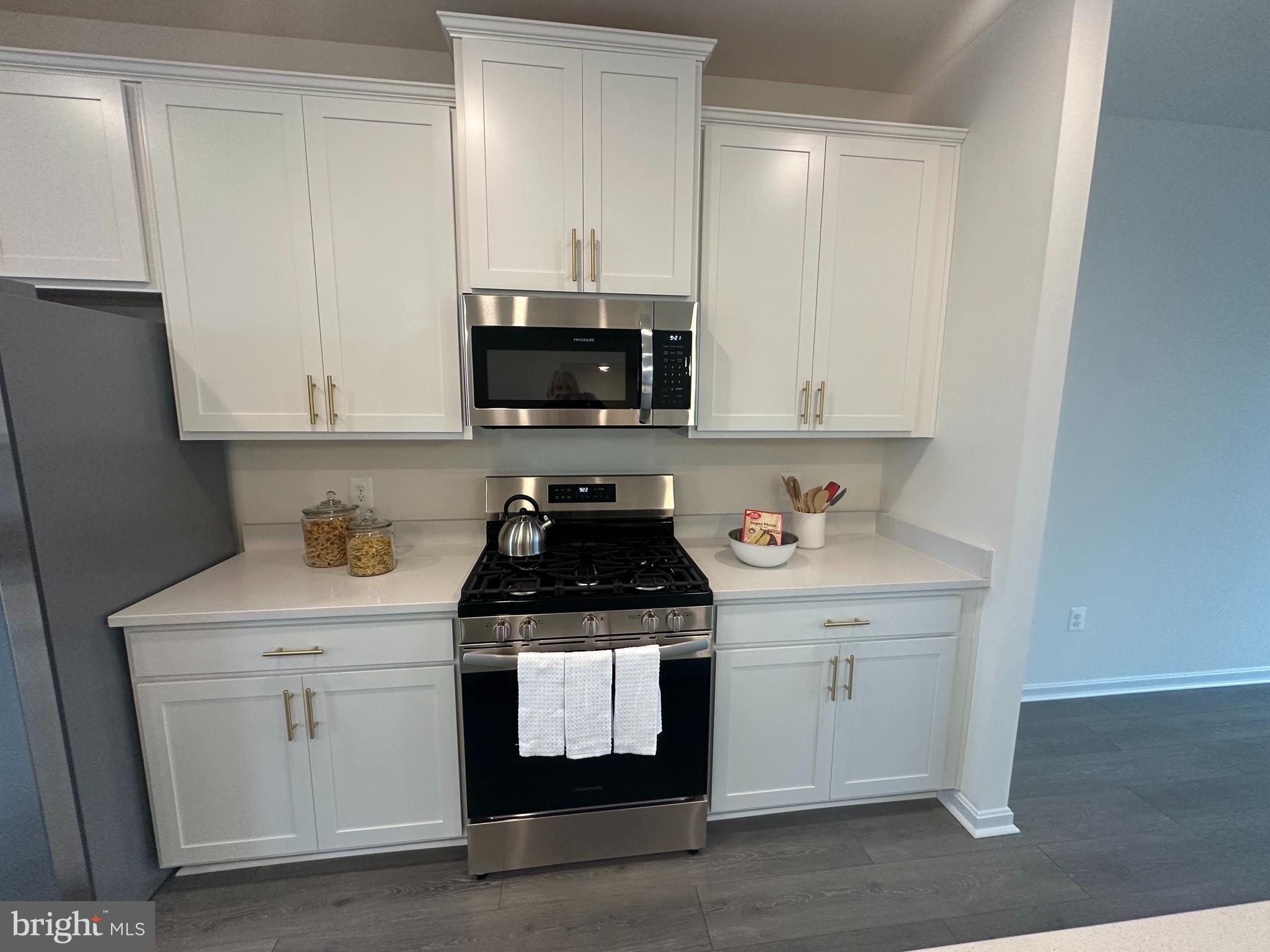 365 Purple Place Edgewood, MD 21040 - Photo 15 of 64 a kitchen with white cabinets and black appliances