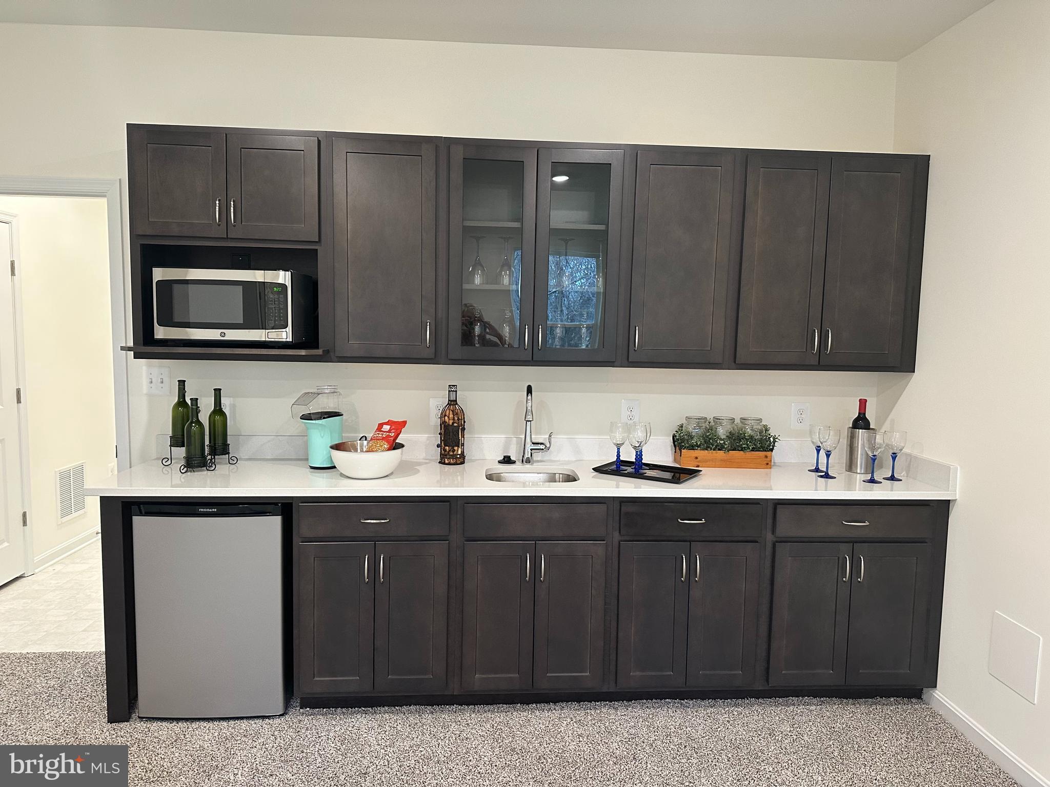 365 Purple Place Edgewood, MD 21040 - Photo 8 of 64 a kitchen with stainless steel appliances granite countertop a sink dishwasher stove and microwave with wooden cabinets