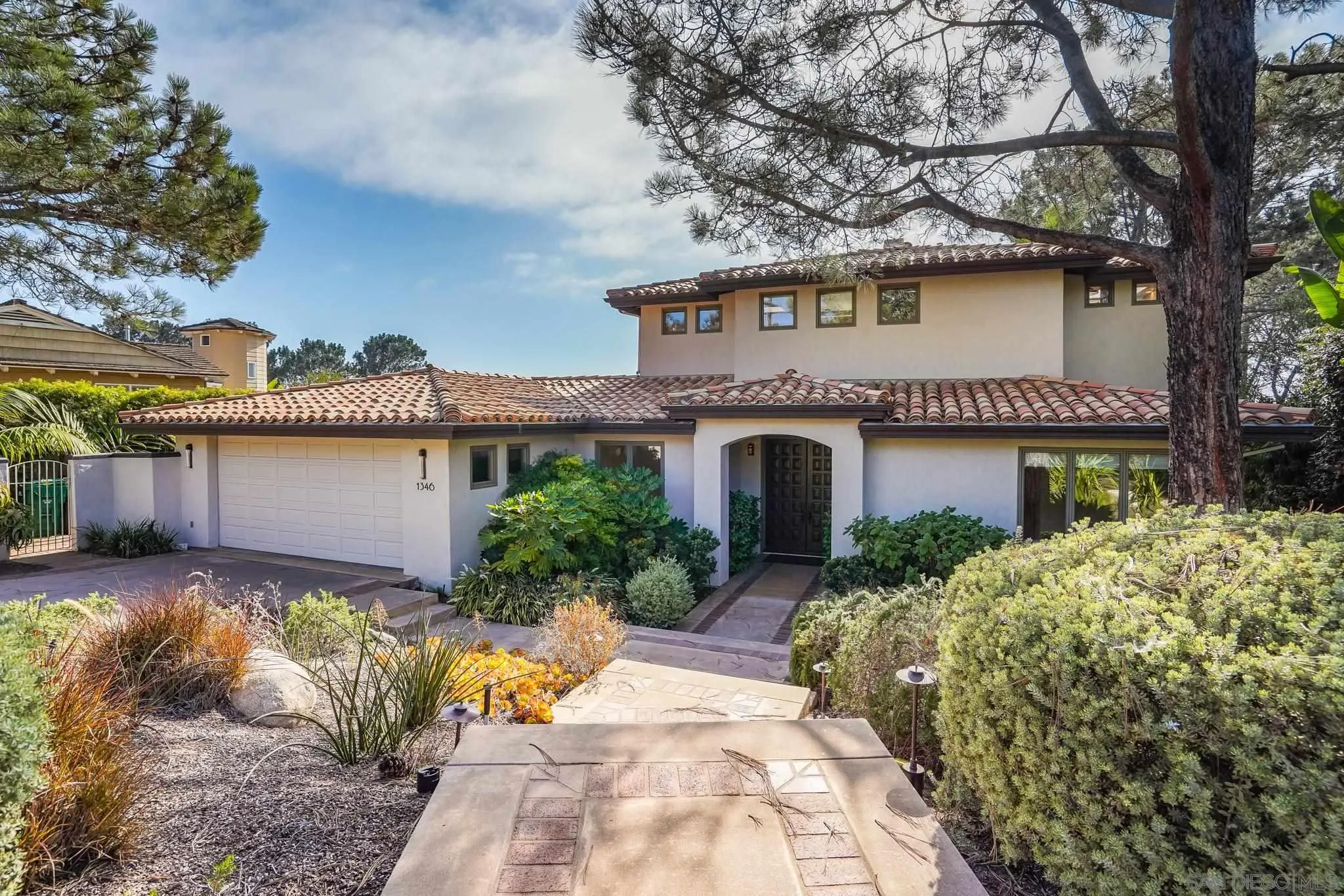 1346 Crest Road Del Mar, CA 92014 - Photo 5 of 64 a front view of a house with a garden