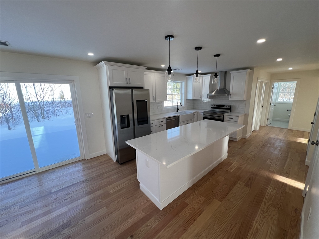 252 East County Road Rutland, MA 01543 - Photo 17 of 42 a large kitchen with stainless steel appliances a large counter top a sink a refrigerator and a window