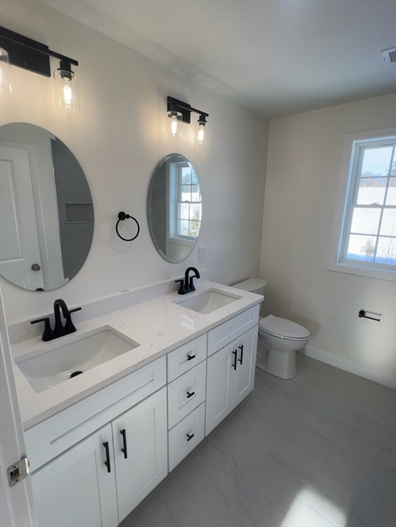 252 East County Road Rutland, MA 01543 - Photo 31 of 42 a bathroom with a double vanity sink and a mirror