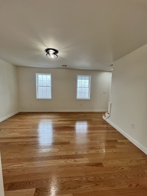252 East County Road Rutland, MA 01543 - Photo 6 of 42 a view of an empty room with wooden floor and a window