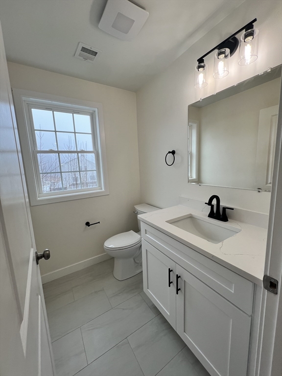 252 East County Road Rutland, MA 01543 - Photo 7 of 42 a spacious bathroom with a double vanity sink a toilet and a mirror