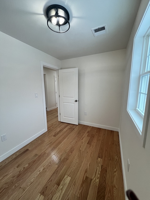 252 East County Road Rutland, MA 01543 - Photo 8 of 42 an empty room with wooden floor and windows