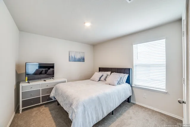 a bedroom with a bed and a tv