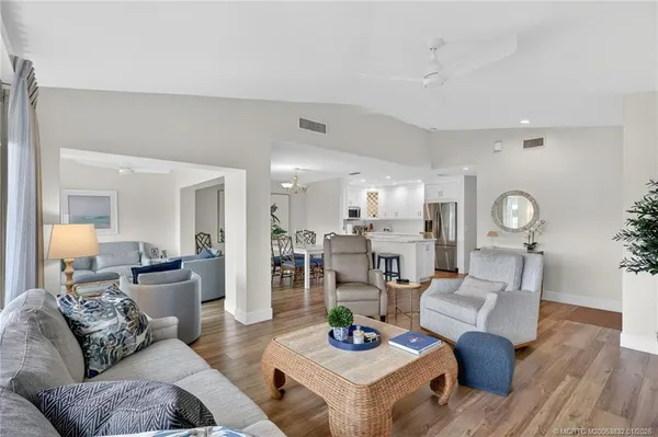 a view of a dining room with furniture a chandelier and wooden floor