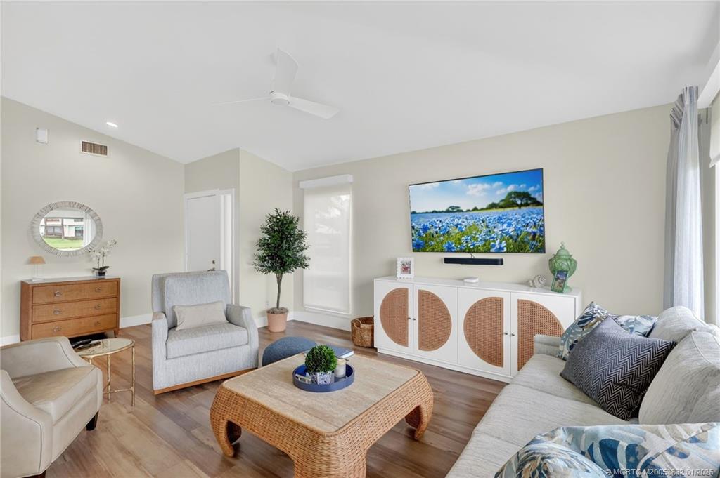 5627 Southeast Foxcross Place Stuart, FL 34997 - Photo 13 of 72 a living room with furniture and a flat screen tv