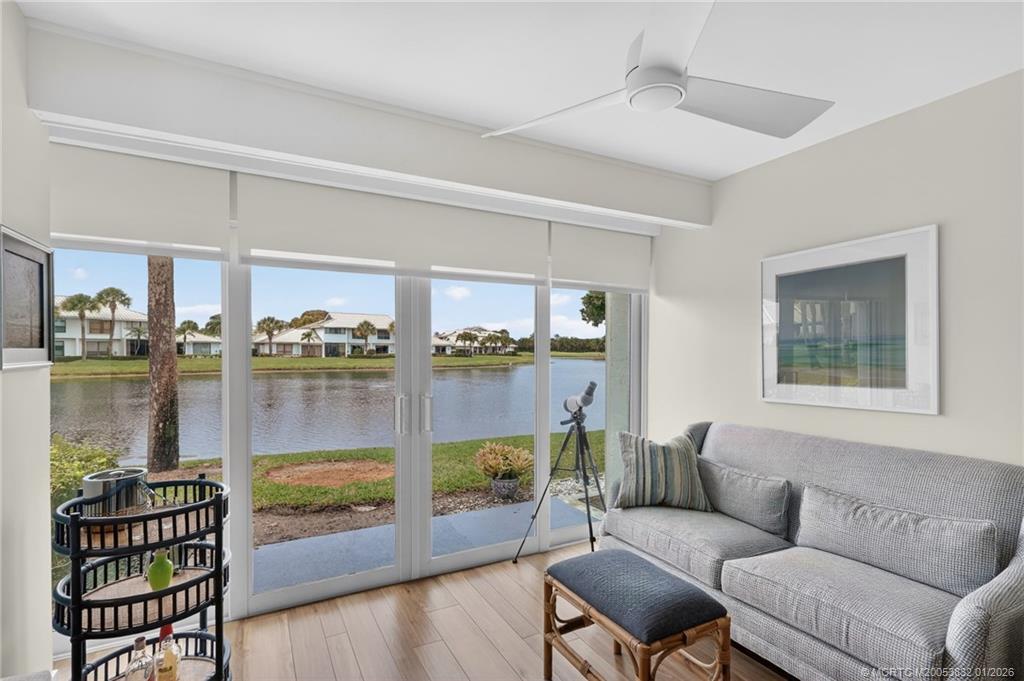 5627 Southeast Foxcross Place Stuart, FL 34997 - Photo 14 of 72 a living room with furniture and a floor to ceiling window