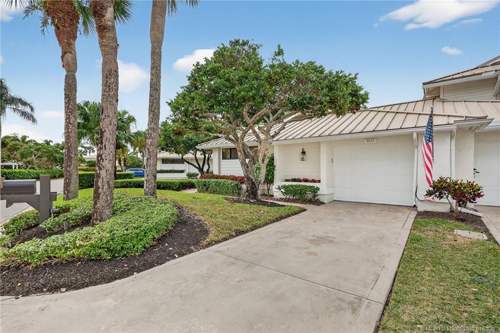 5627 Southeast Foxcross Place Stuart, FL 34997 - Photo 2 of 72 a view of a house with a yard and potted plants