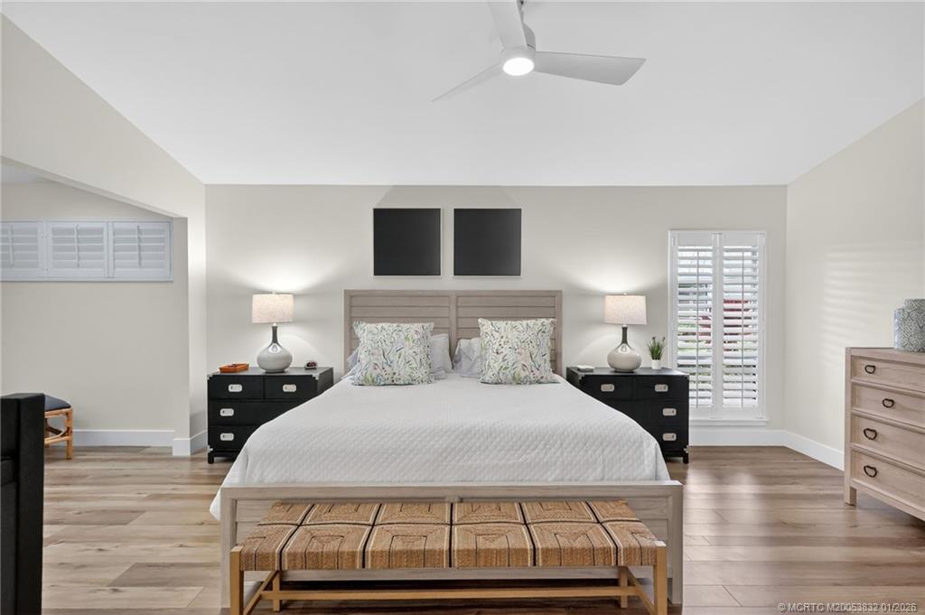 5627 Southeast Foxcross Place Stuart, FL 34997 - Photo 26 of 72 a bedroom with a bed and wooden floor