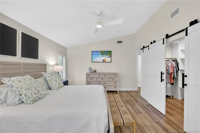 a bedroom with a bed and a night stand