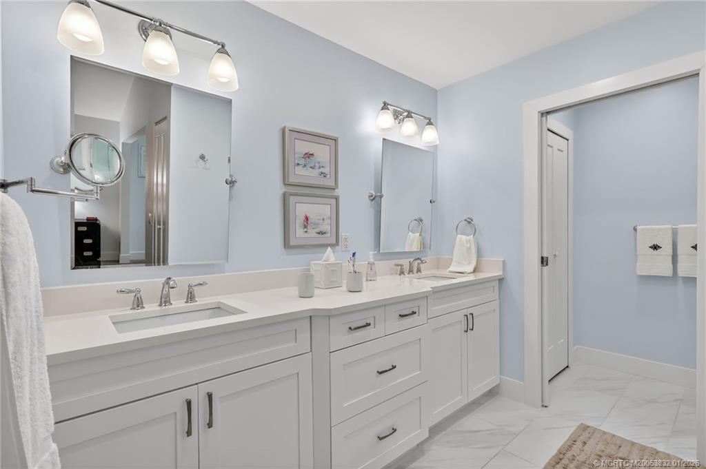 5627 Southeast Foxcross Place Stuart, FL 34997 - Photo 30 of 72 a bathroom with double sink and a mirror