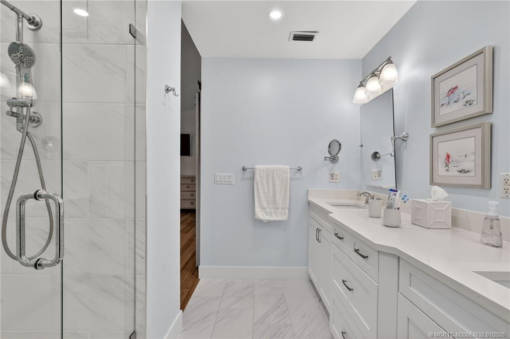 5627 Southeast Foxcross Place Stuart, FL 34997 - Photo 32 of 72 a spacious bathroom with a double vanity sink mirror and double