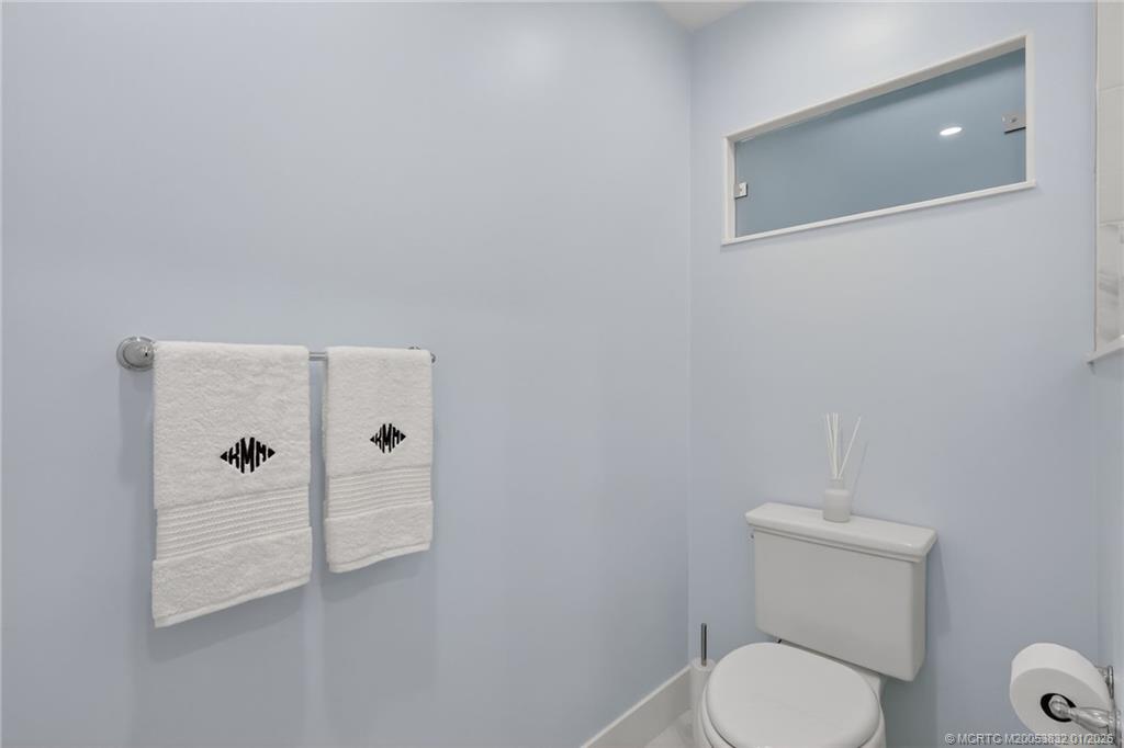 5627 Southeast Foxcross Place Stuart, FL 34997 - Photo 33 of 72 a bathroom with a toilet and a shower