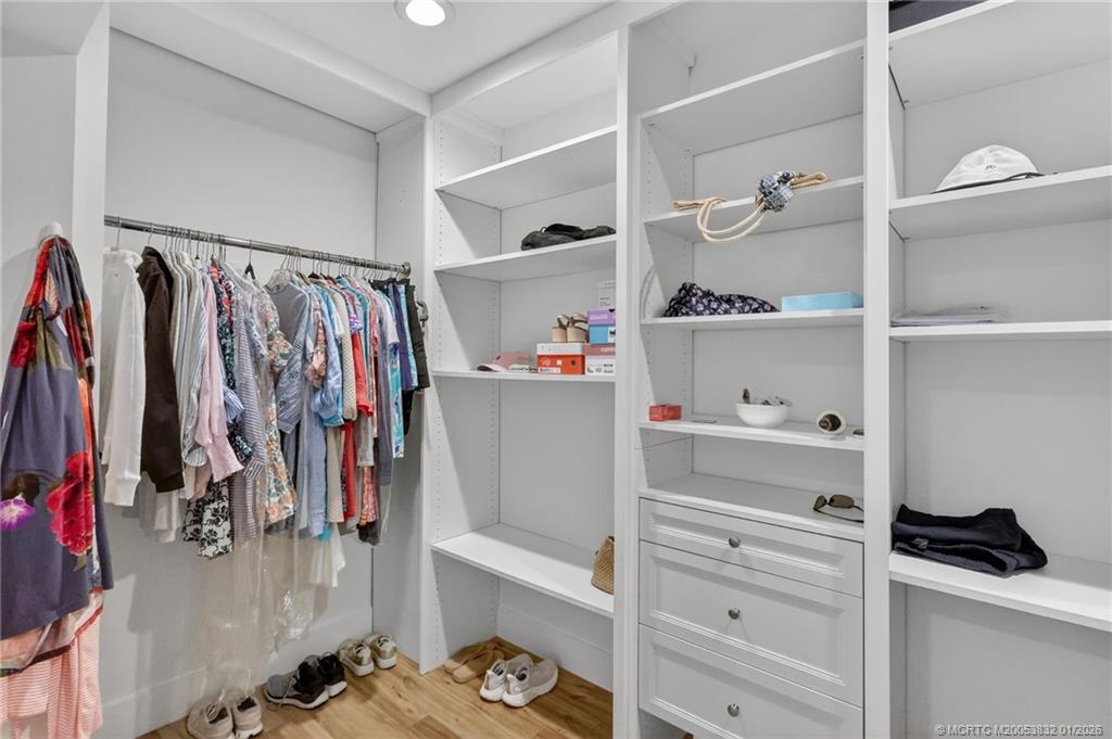 5627 Southeast Foxcross Place Stuart, FL 34997 - Photo 34 of 72 a view of walk in closet with clothes and shoes