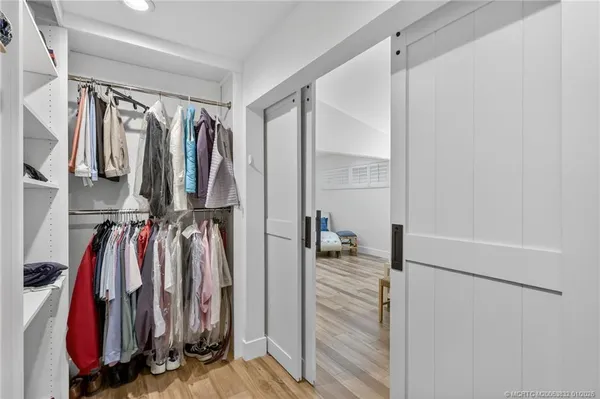 a view of a house with a big yard and potted plants