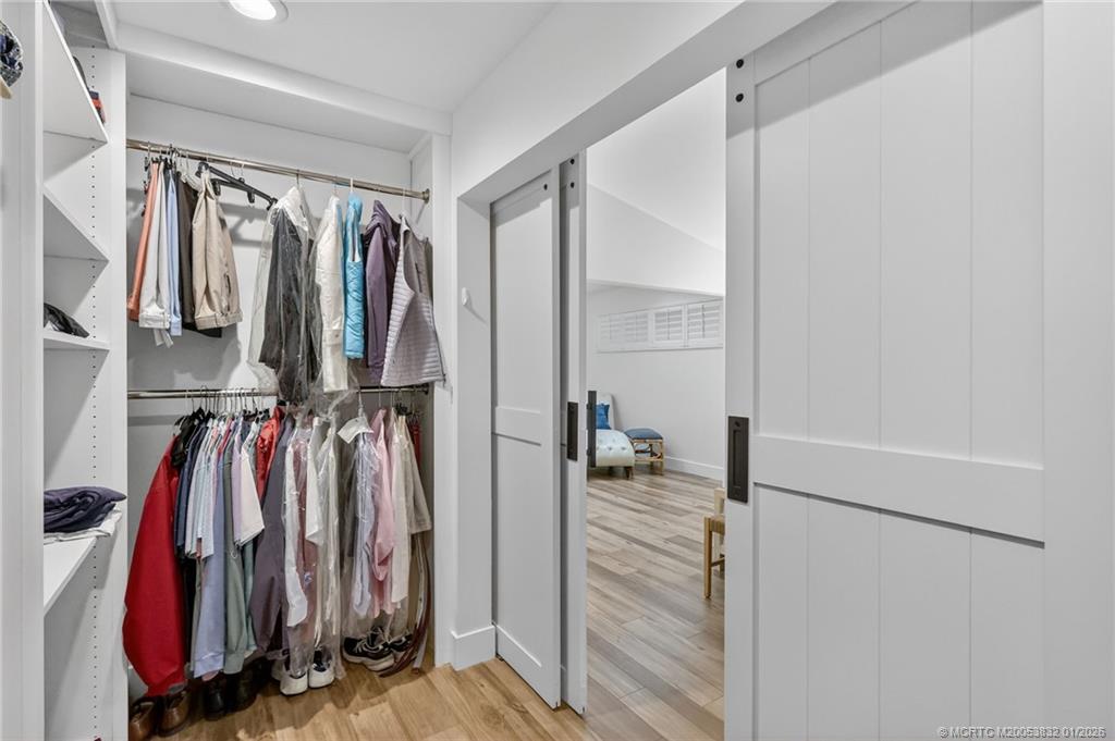 5627 Southeast Foxcross Place Stuart, FL 34997 - Photo 35 of 72 a view of walk in closet with clothes