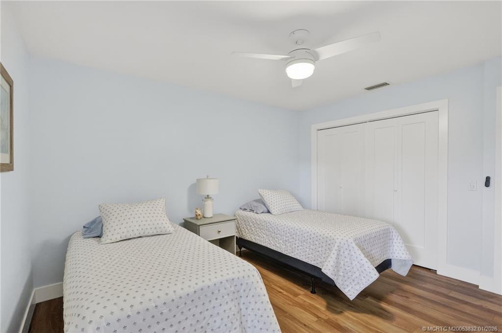 5627 Southeast Foxcross Place Stuart, FL 34997 - Photo 36 of 72 a bedroom with a bed and a night stand