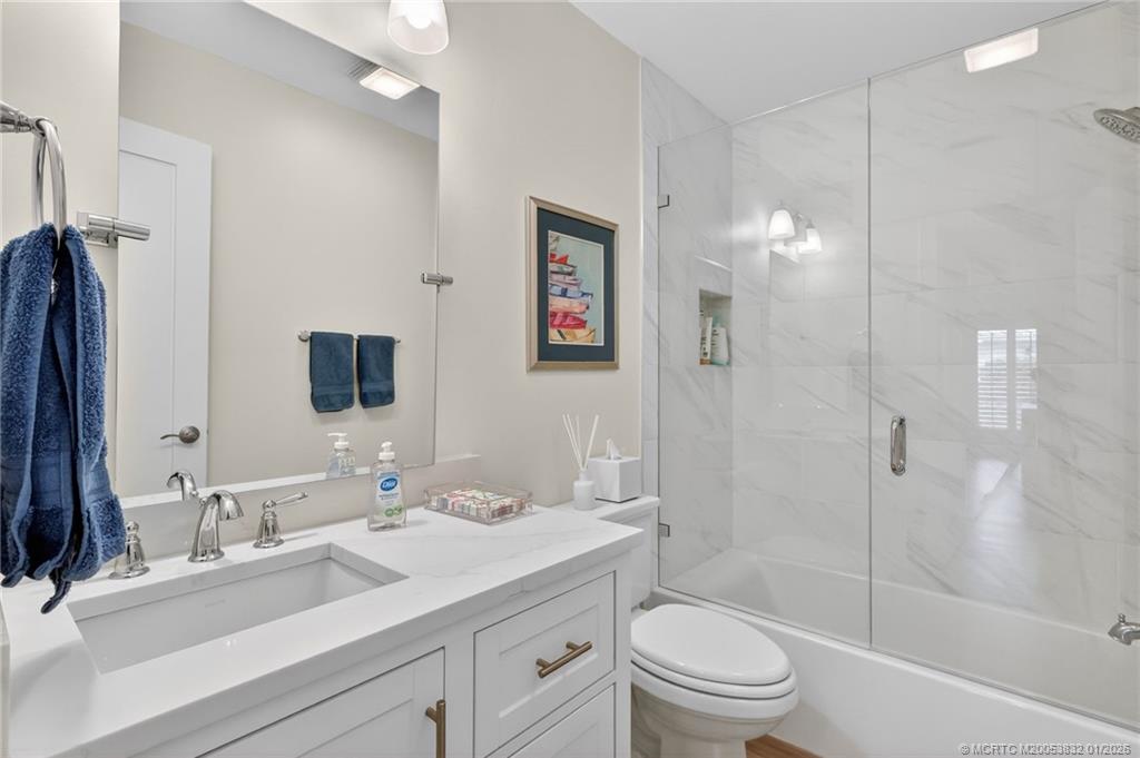 5627 Southeast Foxcross Place Stuart, FL 34997 - Photo 38 of 72 a bathroom with a sink a toilet and shower