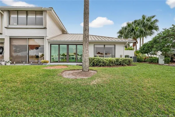 a view of a house with a backyard and a patio