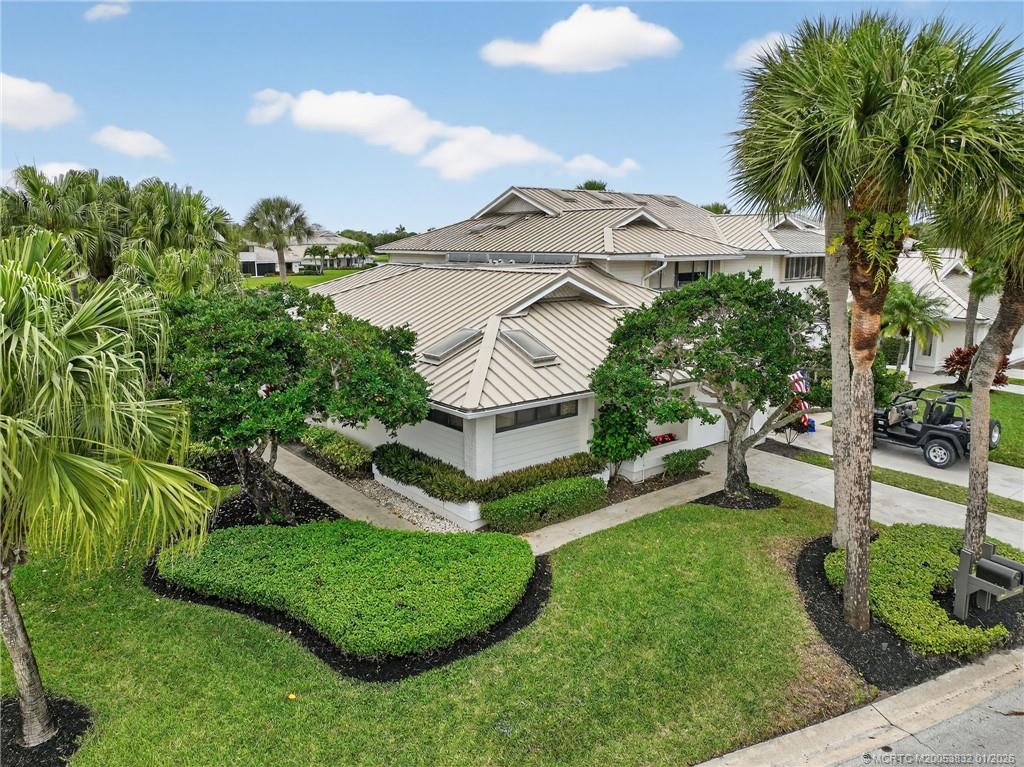 5627 Southeast Foxcross Place Stuart, FL 34997 - Photo 47 of 72 a view of a house with a big yard and potted plants