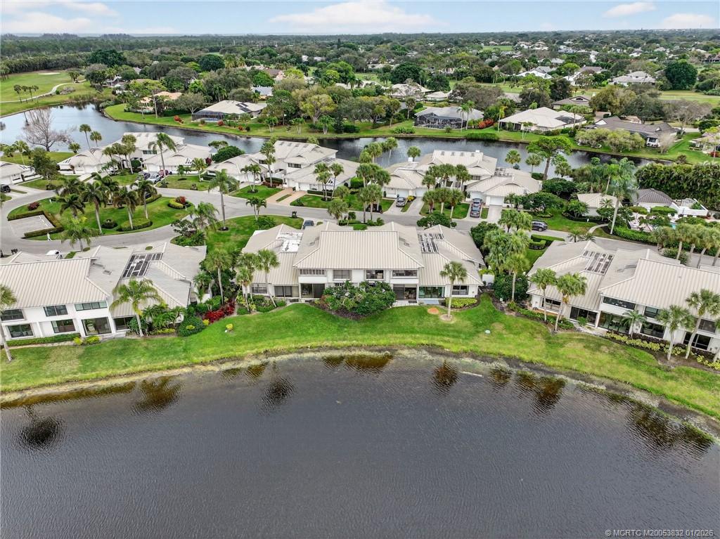 5627 Southeast Foxcross Place Stuart, FL 34997 - Photo 57 of 72 an aerial view of a house with a yard and lake view