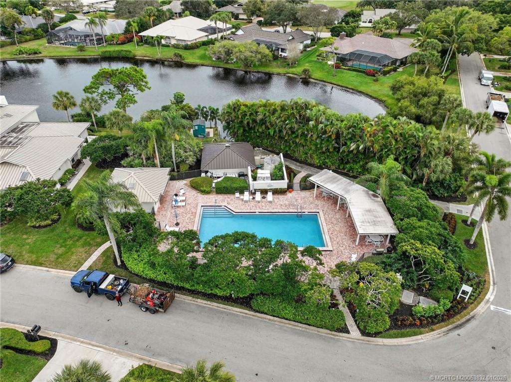 5627 Southeast Foxcross Place Stuart, FL 34997 - Photo 63 of 72 an aerial view of a house with a garden and lake view