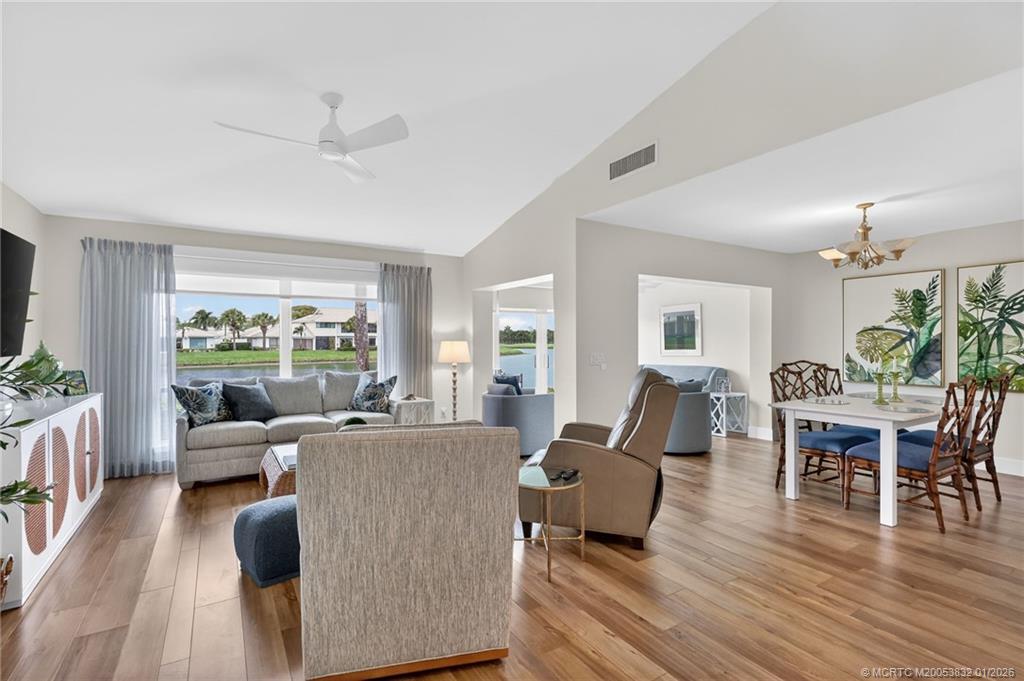 5627 Southeast Foxcross Place Stuart, FL 34997 - Photo 9 of 72 a living room with furniture large window and wooden floor
