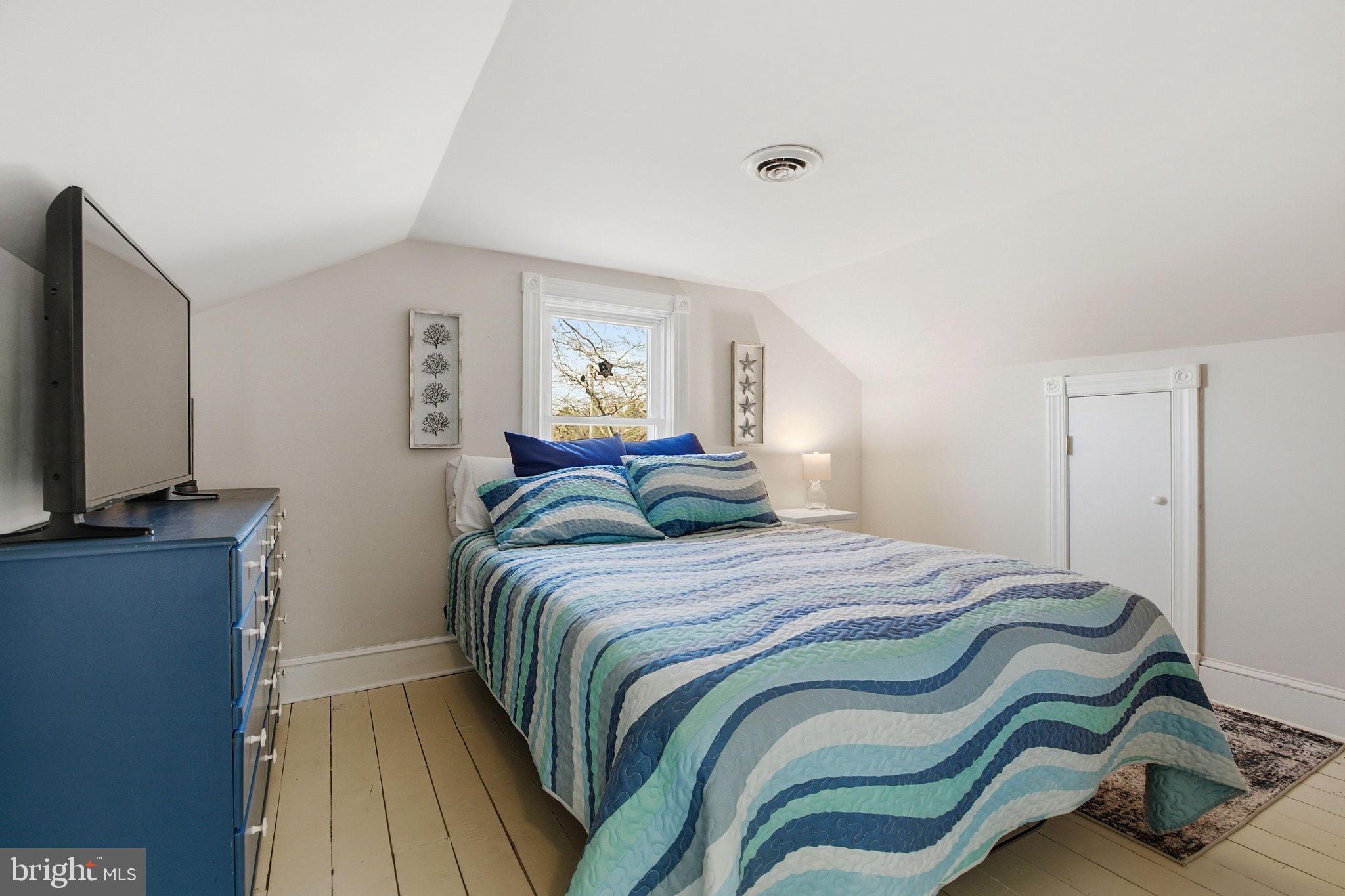 519 Whitehall Road Lancaster, VA 22503 - Photo 26 of 46 a bedroom with a bed and a flat screen tv