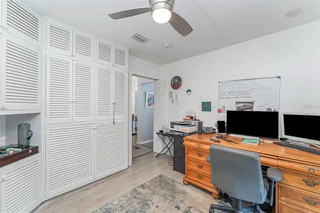 a view of a workspace with furniture and a window