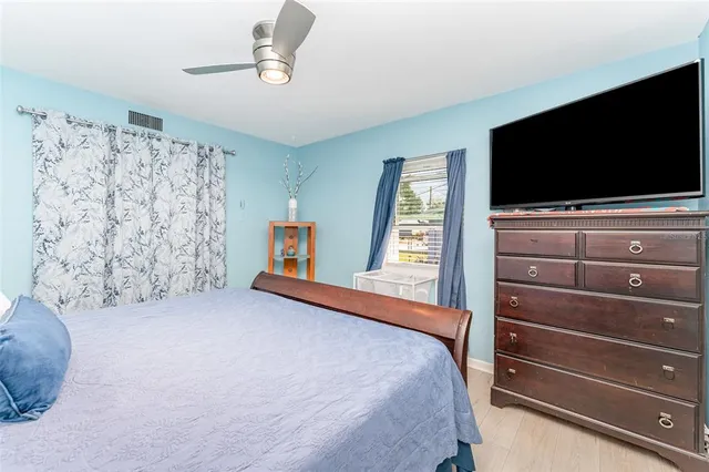 a bedroom with a bed and a flat screen tv