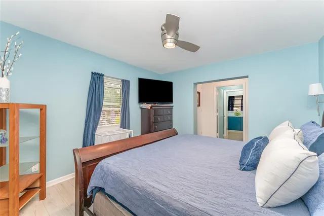 a bedroom with a large bed and a flat screen tv