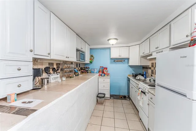 a kitchen with cabinets and window