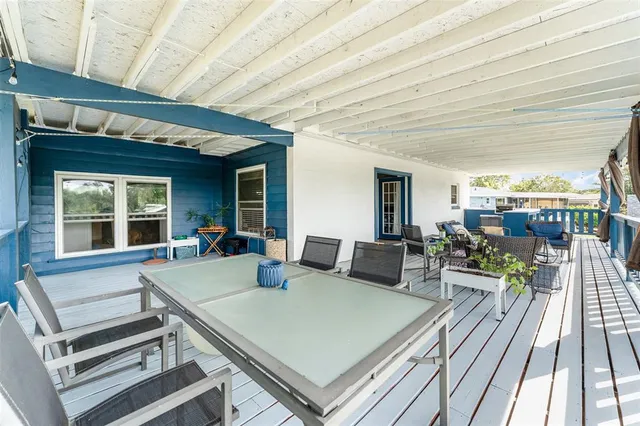 a view of a dining hall with couches and wooden floor