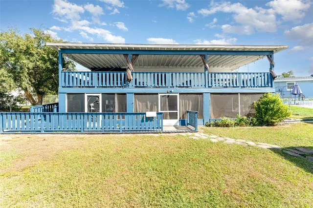 a view of a house with a swimming pool and a yard