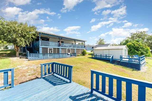 a view of a house with pool and sitting area