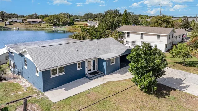 an aerial view of a house with a yard