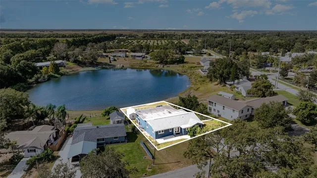 an aerial view of a house with a lake view