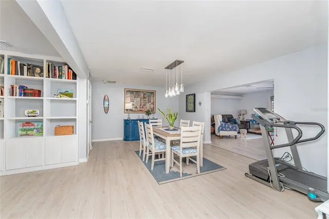 a dining room with furniture and wooden floor