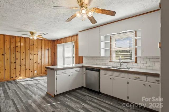 a kitchen with a sink cabinets and window
