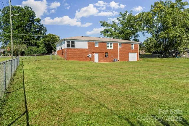 a view of a big yard with large trees