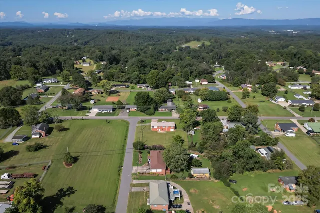 an aerial view of a houses with a yard