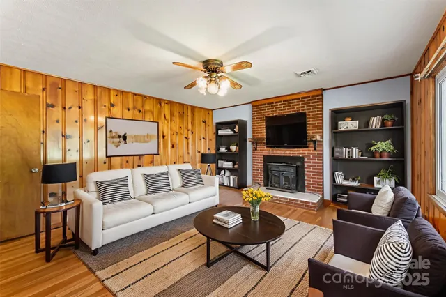 a living room with furniture a fireplace and a flat screen tv
