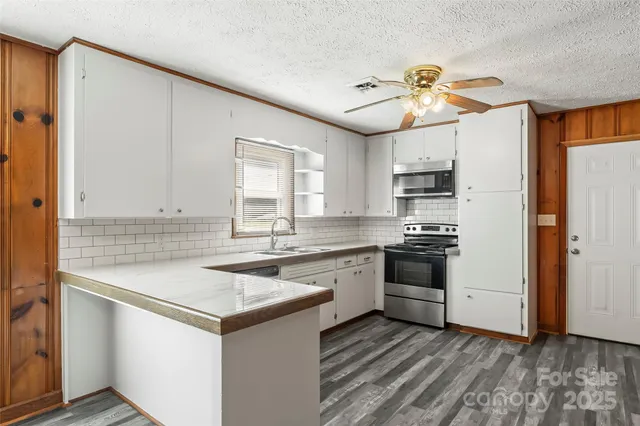 a kitchen with a white stove top oven cabinets and a refrigerator