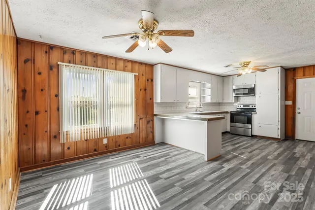 a view of a kitchen with a stove cabinets and wooden floor