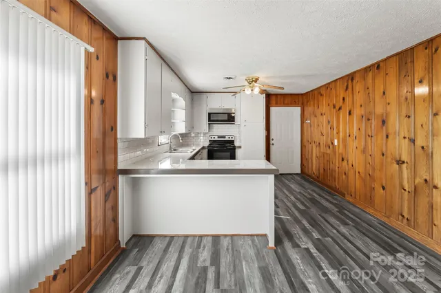 a kitchen with a sink and wooden floor