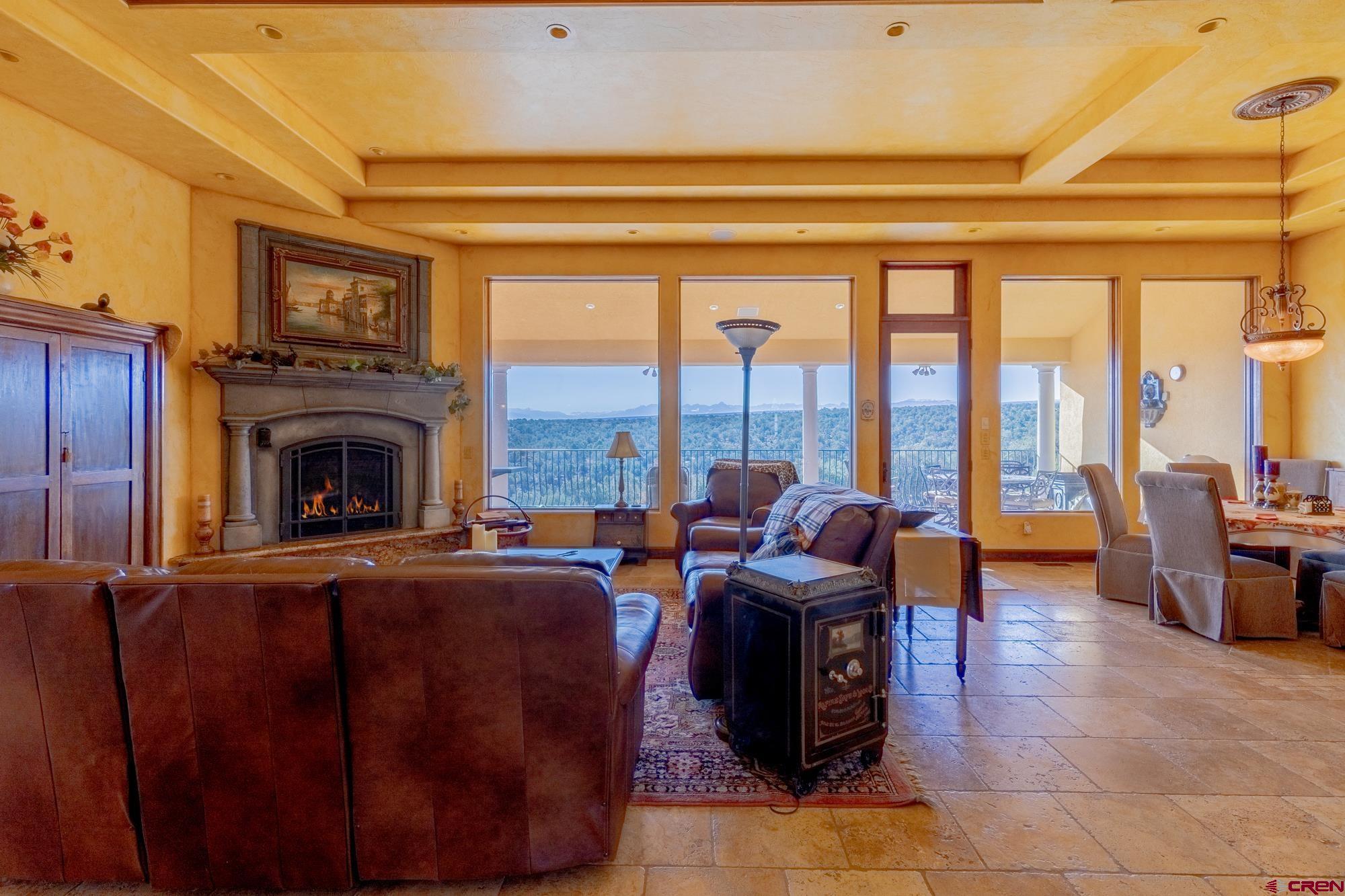 19754 Dave Wood Road Montrose, CO 81403 - Photo 11 of 35 a living room with furniture large window and a fireplace