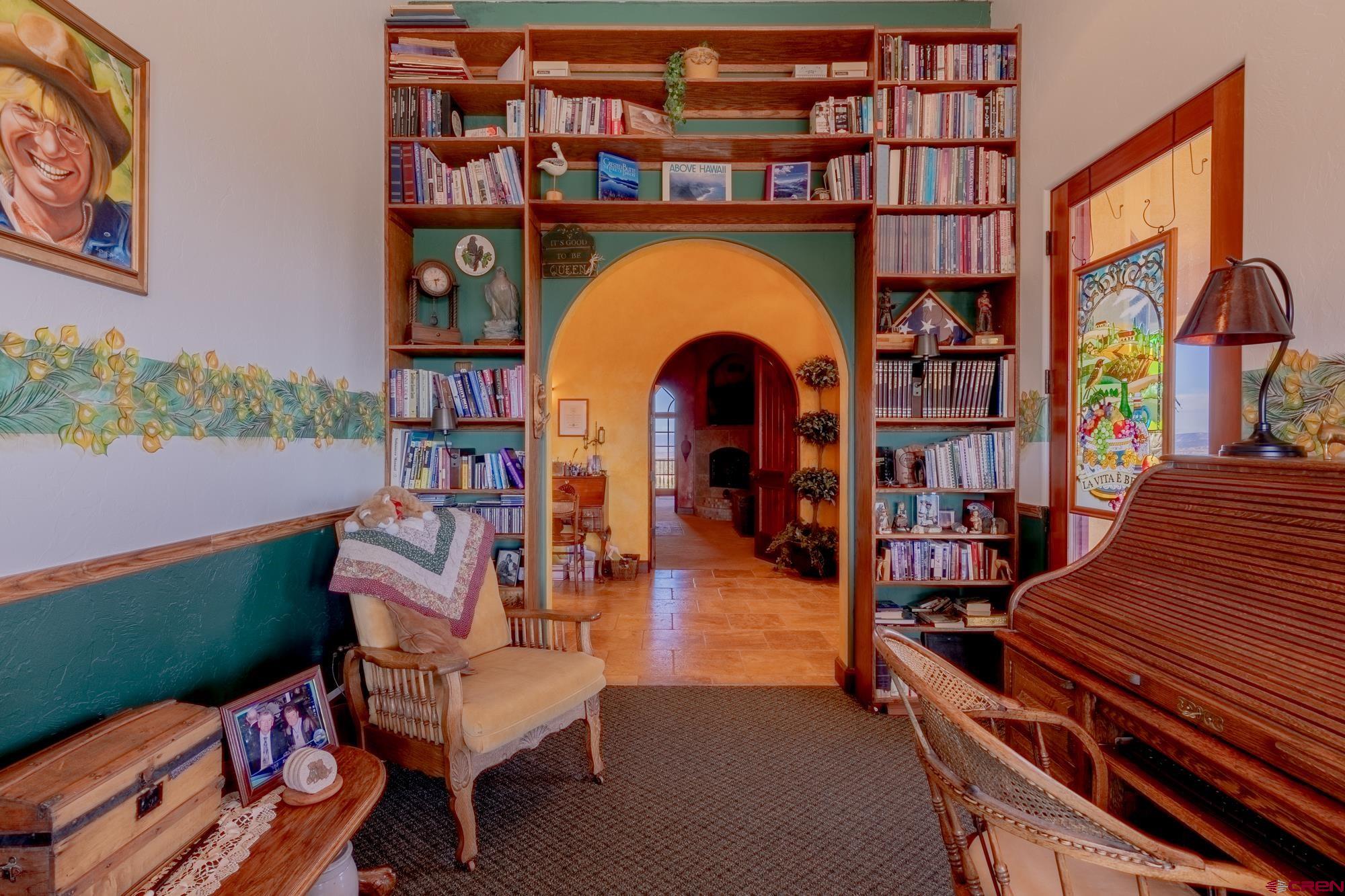 19754 Dave Wood Road Montrose, CO 81403 - Photo 25 of 35 a living room with furniture and a book shelf