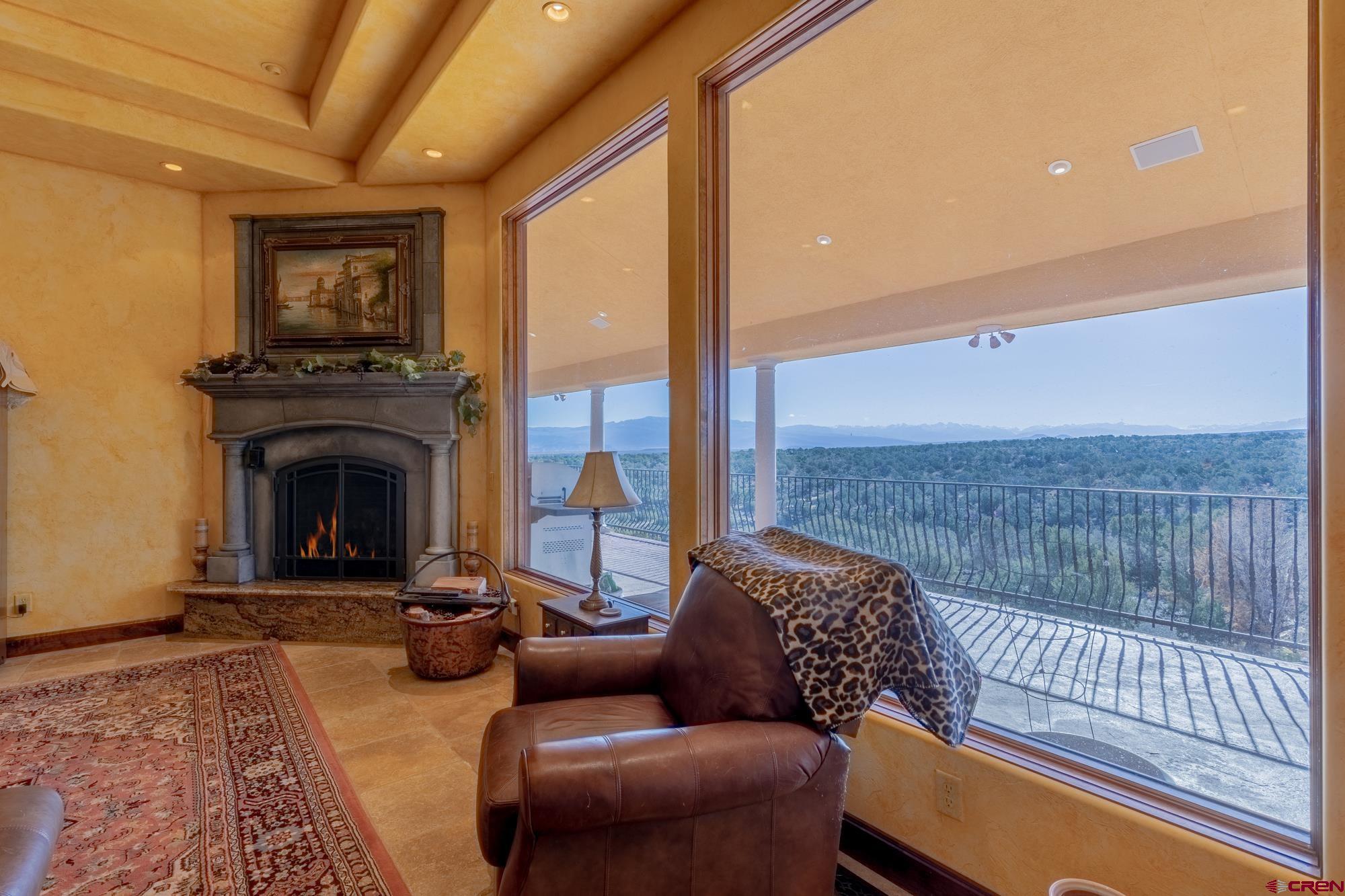 19754 Dave Wood Road Montrose, CO 81403 - Photo 30 of 35 a living room with furniture and a fireplace